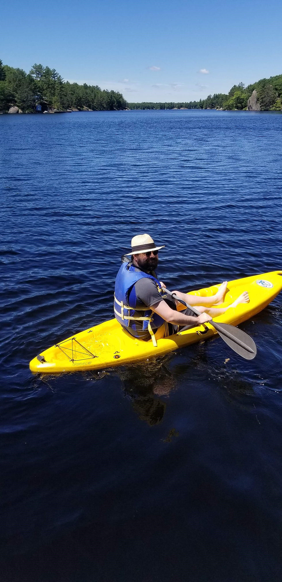 Man paddling a kayak in Muskoka