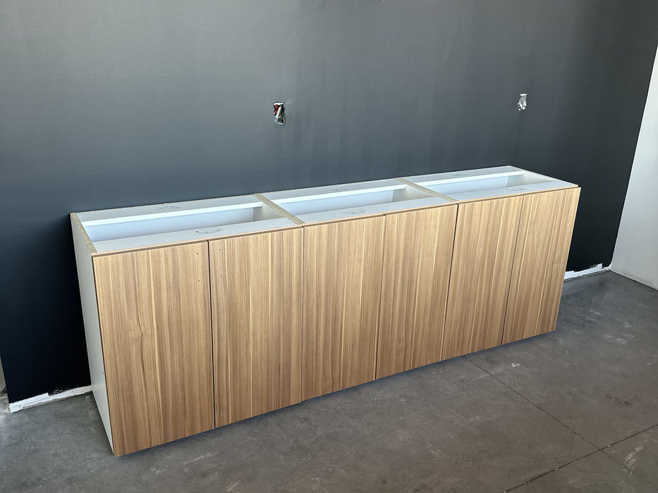 Light wood cabinet against dark wall, room under construction