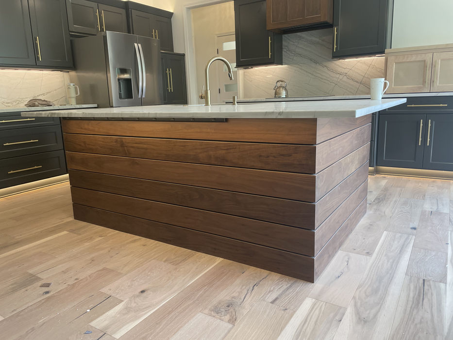 Modern kitchen with dark wood island, light counter