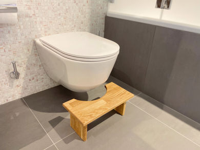 Tabouret de toilettes en bois dans une salle de bain