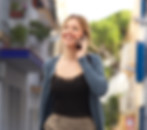 attractive-young-woman-walking-with-suitcase-talking-cellphone
