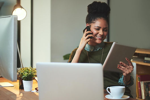 Woman looking at her iPad and talking on the phone.