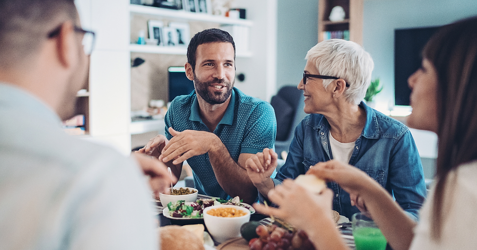 Extended family gathered around kitchen table talking and setting boundaries