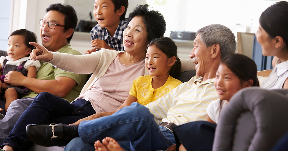 family sitting on couch watching a holiday movie laughing after setting boundaries