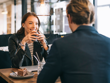 Man and woman having coffee and eating cake