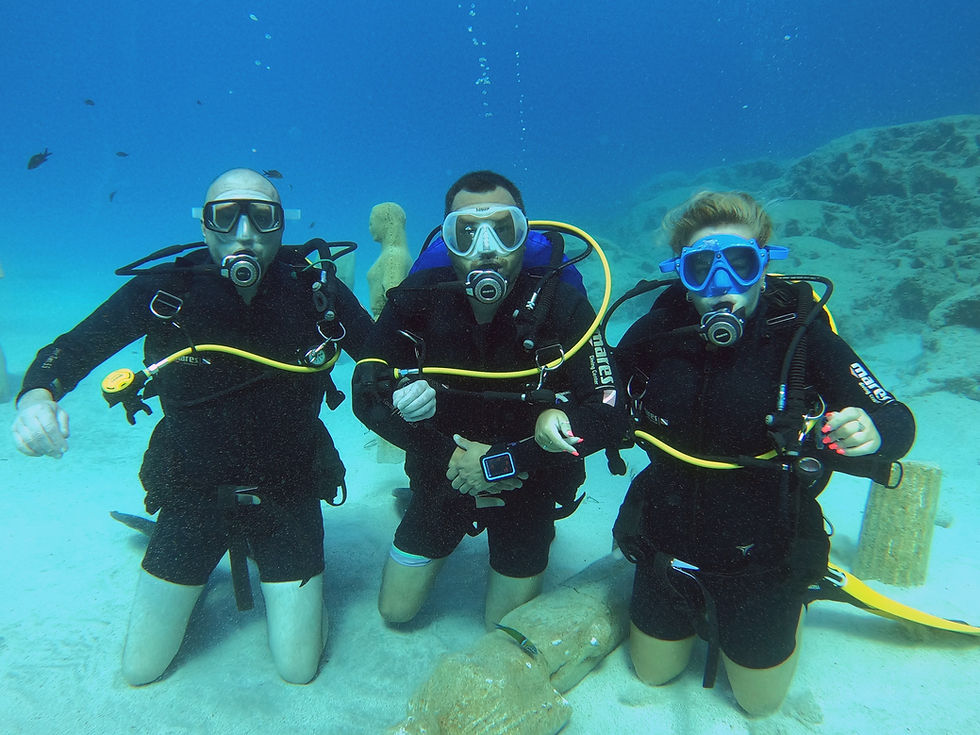 Three scuba divers under water in ayia napa