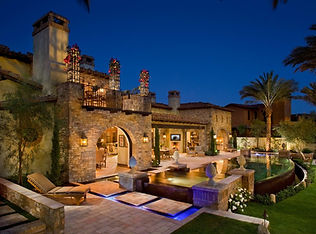 House with stone exterior, landscaping and brick paving stones