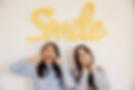 Two Women Showing Smiles.png