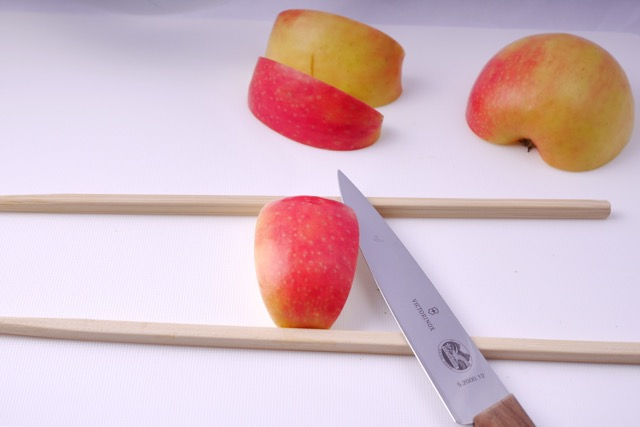Place apple between chopsticks
