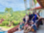 Group of people on the stairs with jungle in the background