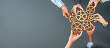 Panoramic shot top view of business people holding cog wheel as unity and teamwork in corp