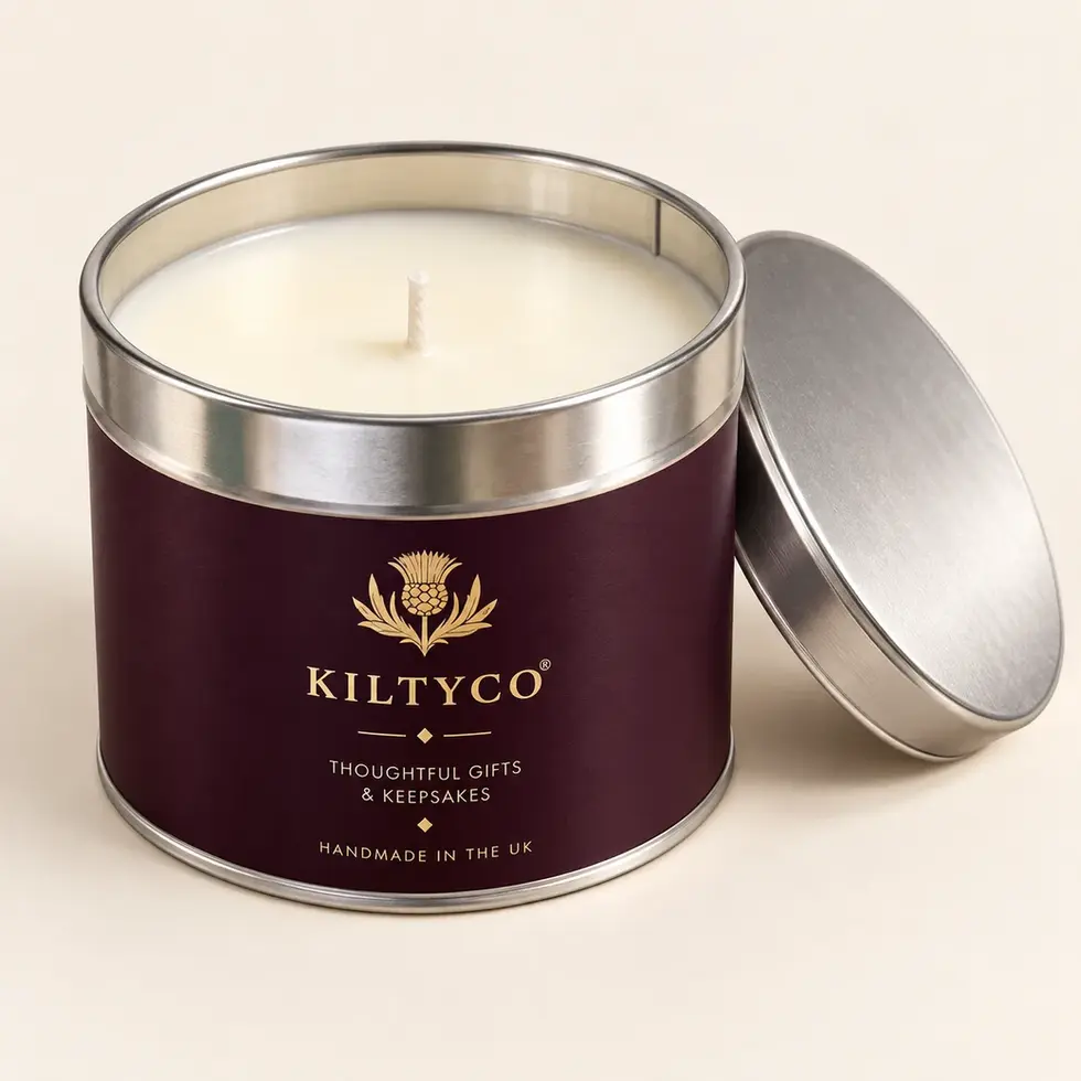 Unlit Spirit of Scotland candle in a plum-and-gold Kiltyco tin with its silver lid alongside