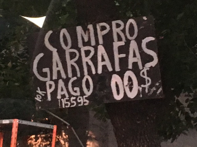 Sign on the road, where it says "I buy bottles. I pay $0.'