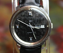 Elgin - Automatic All Stainless Steel with a Seldom Seen Corduroy Black Textured Dial Wristwatch - (circa 1960s)