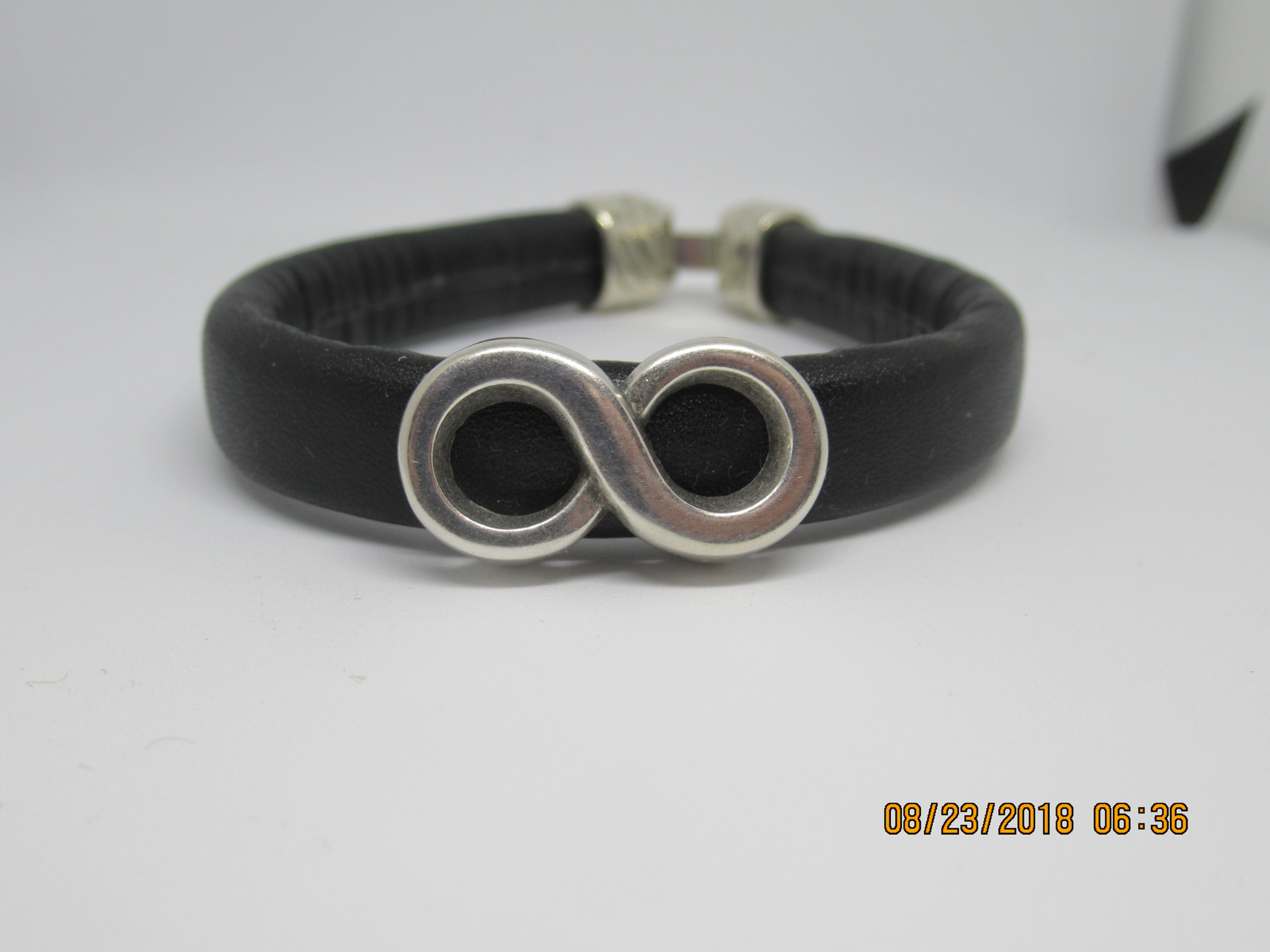 Man's bracelet leather band with infinity sign