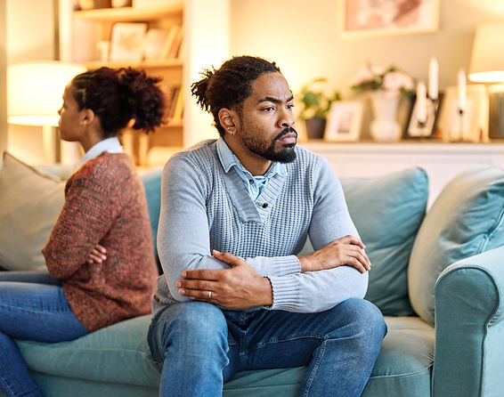man-and-woman-sitting-separately-on-a-couch-2026-03-25-04-16-29-utc.jpg