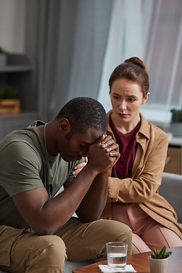 concerned-woman-comforting-man-with-hands-clasped-2026-03-18-17-41-59-utc.jpg