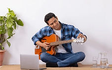 young-music-teacher-tuning-guitar-260nw-2451534075_edited.jpg