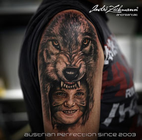 Tattoo of a wolf head over a painted face, austrian perfection since 2003, Andre Zechmann.