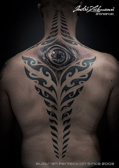 Rear view of a person with elaborate tattooed eye patterns, Superb Zechmann.
