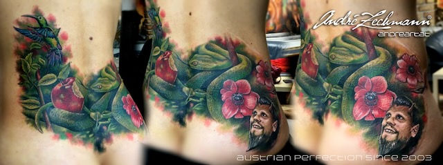 Tattoo on skin with flowers, an apple and the Andre Zechmann lettering.