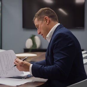 Costello Group Representative looking at commercial property lease fine print