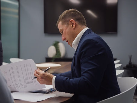 Costello Group Representative looking at commercial property lease fine print