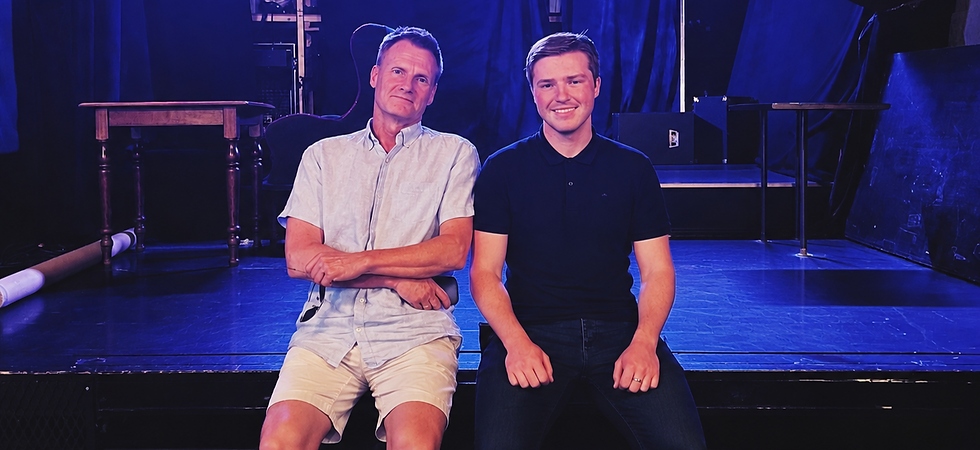 Two Men Beneath Blue Stage Lights_edited