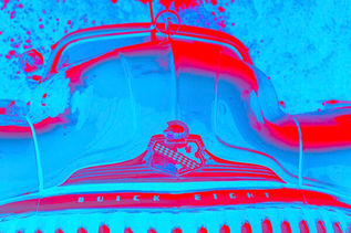 A stylized, high-contrast close-up of the front hood of a vintage classic car. The image is rendered in a dual-tone neon palette of bright cyan blue and hot red. The word "BUICK EIGHT" is embossed along the chrome trim, sitting directly beneath a detailed classic Buick crest emblem.