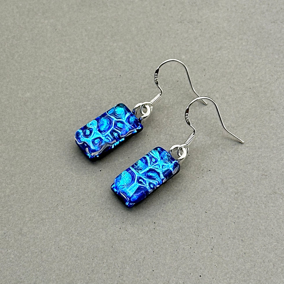 Thumbnail: Handmade blue raindrop dichroic fused glass dangle earrings with colour-shifting effect by Jade Tapson.
