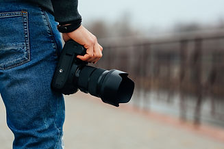 close-up-view-male-hand-holding-professional-camera-street.jpg
