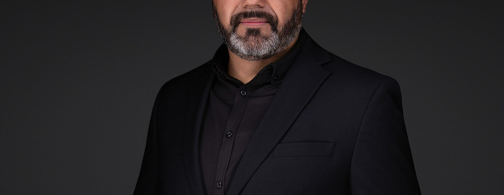 Headshot of man in black shirt for Central Coast Sign and Design.”