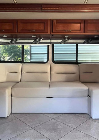 RV sectional sofa with pull-out bed reupholstered in cream leather
