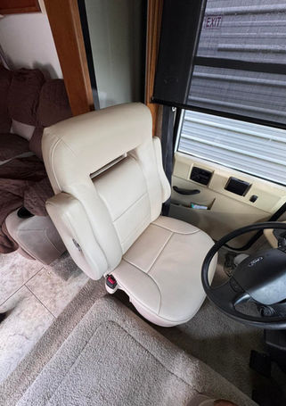Cream leather RV captain's chair during installation