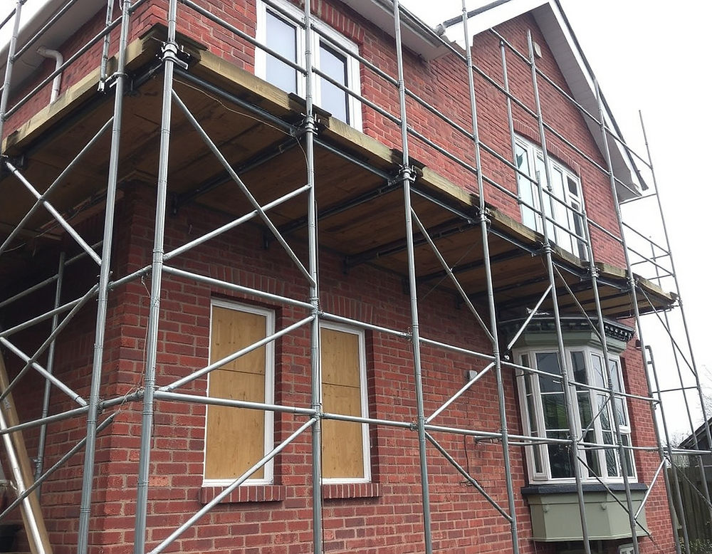 House with scaffolding, building maintenance services London