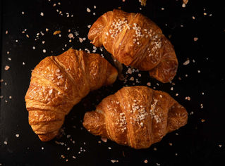 croissants on black background photographed by Miami food photographer Kathleen Ballard