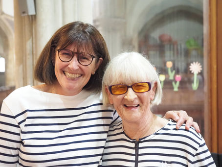 Two smiling alto members of the choir