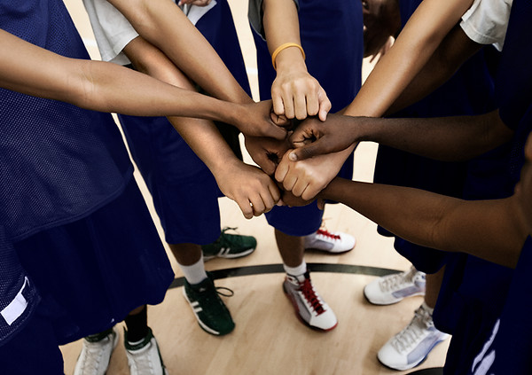 Team Putting Fists Together In Huddle_ed