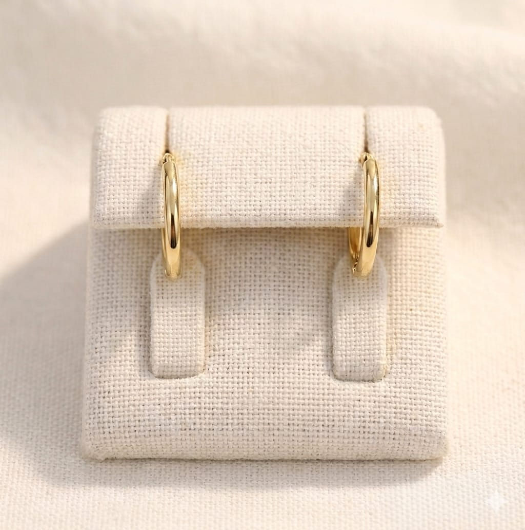 Gold celestial layered lariat hoop earrings on display