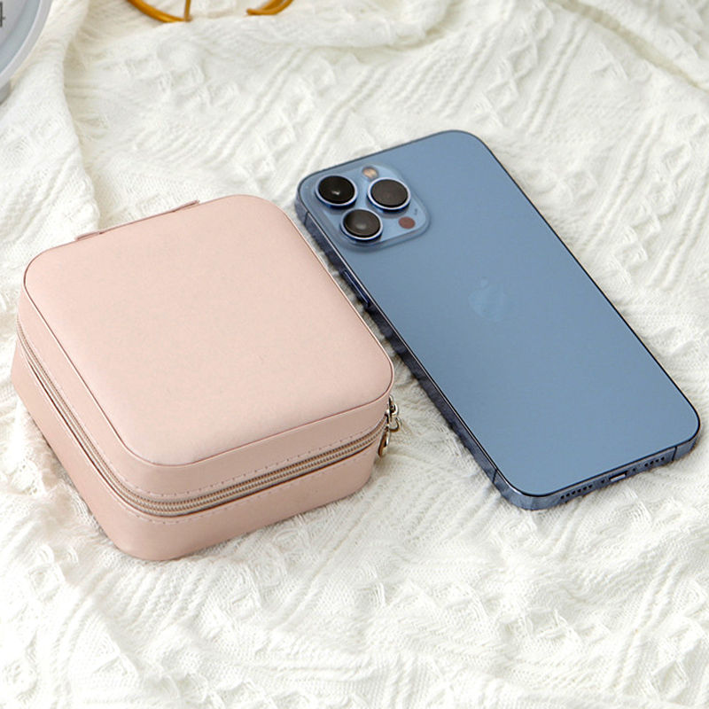 Thumbnail: Small pink The Clarity Solitaire jewelry case next to a smartphone