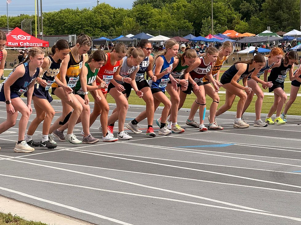 Eye-level view of a young athlete tying running shoes on a track