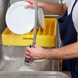 Employee washing dishes
