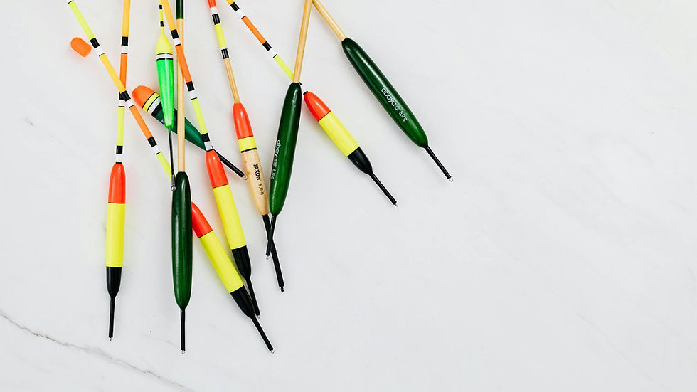 A collection of colorful fishing floats displayed on a white marble surface.