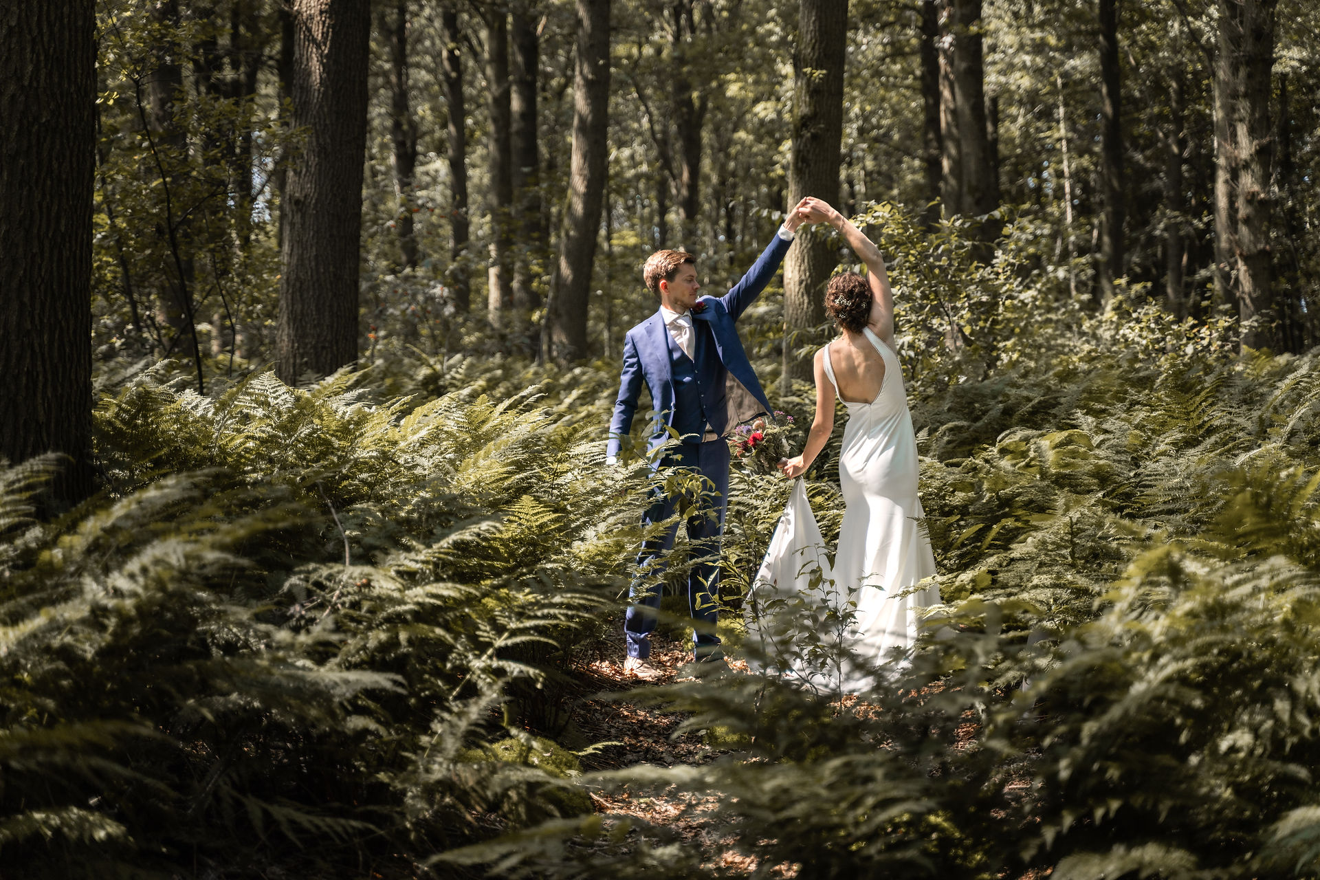 Love shoot tussen de varens dansen onder de bomen bruiloft