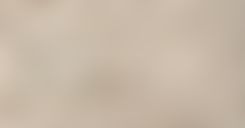 Smooth stones resting on sand with soft linen textures in muted earth tones, reflecting natural rhythm and calm pacing