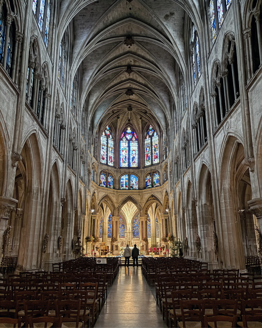 Interior of Saint-Séverin church in Paris with Gothic arches and stained glass windows