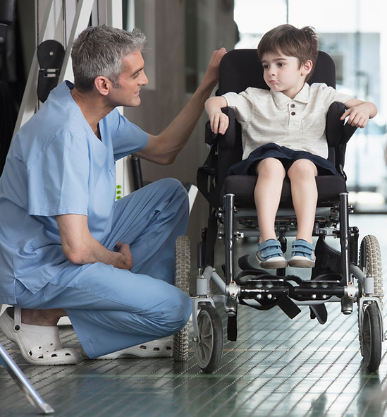 Doctor Talking to Boy in Wheelchair