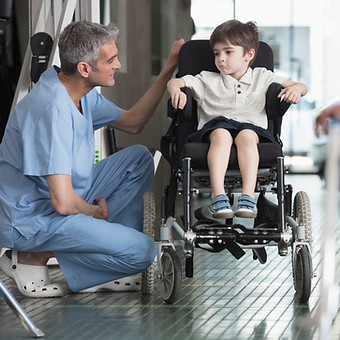 Doctor Talking to Boy in Wheelchair