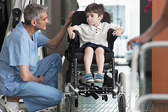Doktor Talking to Boy im Rollstuhl