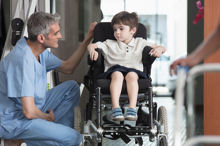 Doctor Talking to Boy in Wheelchair